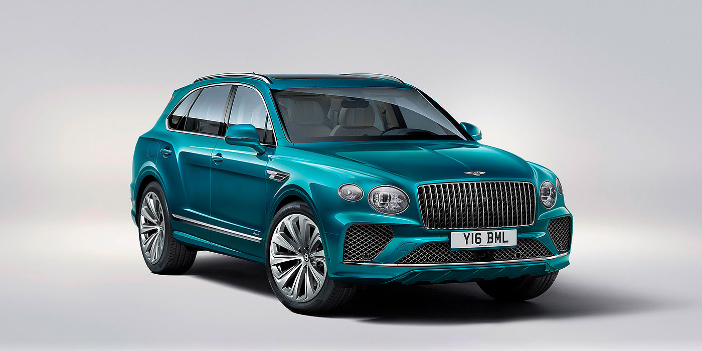 Bentley Monaco Bentley Bentayga Azure front three-quarter view, featuring a fluted chrome grille with a matrix lower grille and chrome accents in Topaz blue paint.