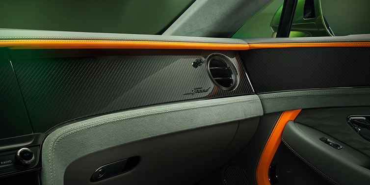 Bentley Monaco Bentley Continental GT Speed coupe front interior dash detail with high gloss carbon fibre veneer surrounded by Mandarin by Mulliner and Gravity Grey hides