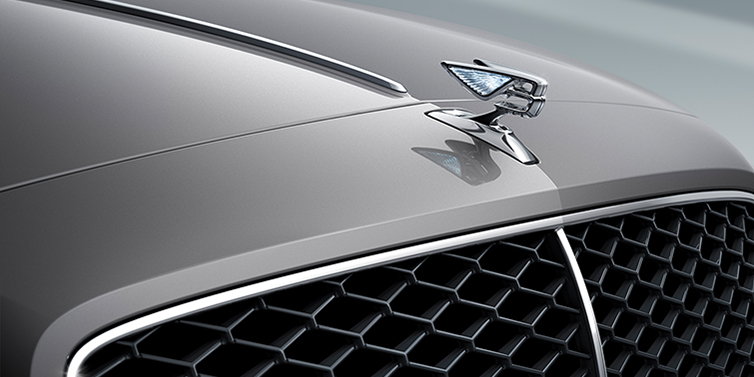 Bentley Monaco New Bentley Flying Spur sedan bonnet detail in Silverlake paint with Illuminated Flying B bonnet badge and matrix grille with chrome surround