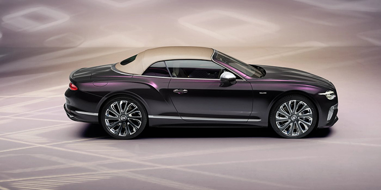 Bentley Monaco Bentley Continental GTC Mulliner convertible in profile with hood up, in Tanzanite Purple paint and 22 inch Mulliner painted and polished wheels