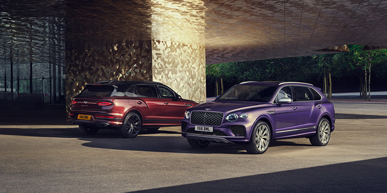 Bentley Monaco A duo of Bentley Bentayga Extended Wheelbase Mulliner SUVs parked in a city environment, with Tanzanite Purple and Cricket Ball red exterior paint