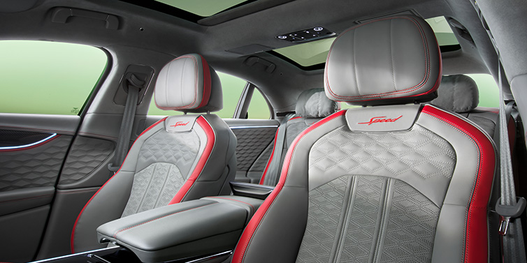 Bentley Monaco Bentley Flying Spur Speed sedan interior showing front and rear seats in Hotspur red and Gravity Grey hides, with Speed seat emblems