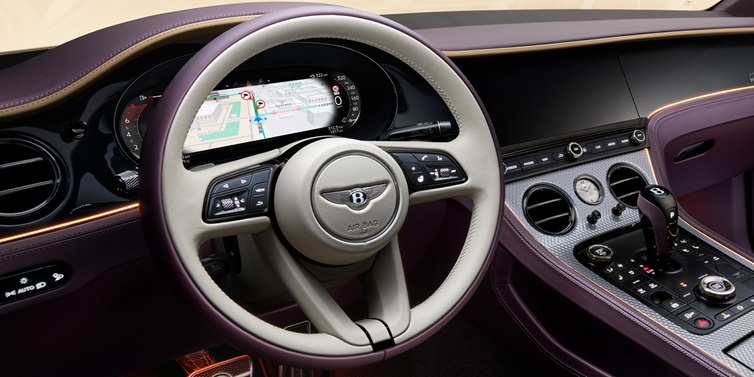 Bentley Monaco Bentley Continental GT Mulliner coupe front interior showing steering wheel and drivers screens surrounded by Linen and Damson hides and Grand Black veneer