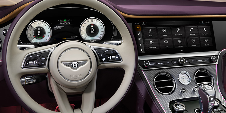 Bentley Monaco Bentley Continental GTC Mulliner convertible steering wheel and drivers screens surrounded by Damson purple and Linen hides